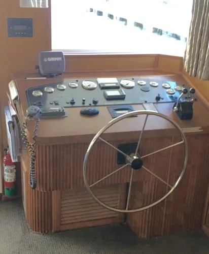 Slide: The Image of 2004 Sumerset Kapalua Share #13 boat helm with steering wheel and control panel. - 2