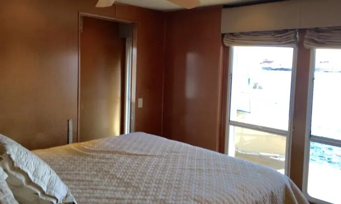 Slide: The Image of Bedroom interior of 2004 Sumerset Kapalua Share #13 houseboat with large windows. - 4
