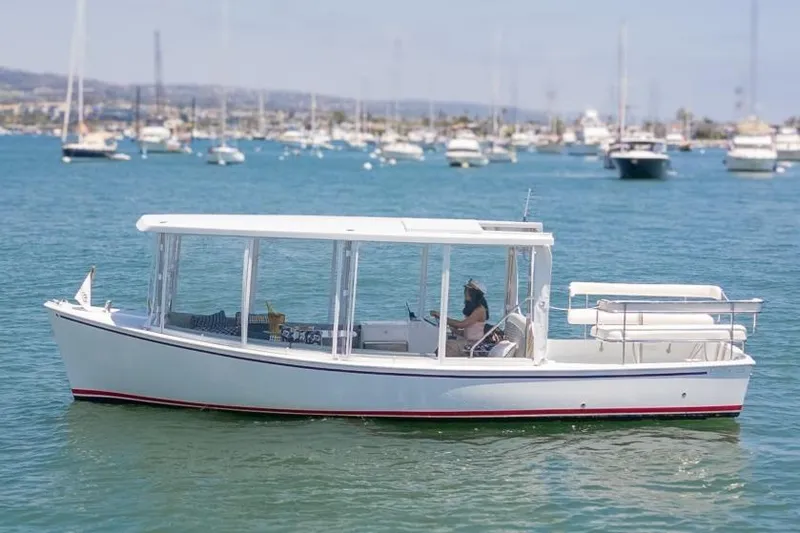 Slide: The Image of 2025 Duffy Sun Cruiser boat on calm water, surrounded by other boats in the background. - 10
