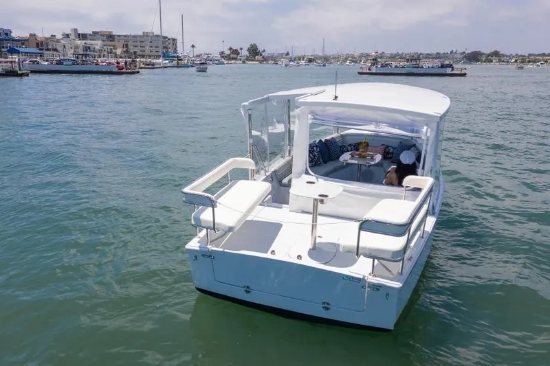 Slide: The Image of 2025 Duffy Sun Cruiser boat on calm waters, featuring spacious seating and modern design. - 9