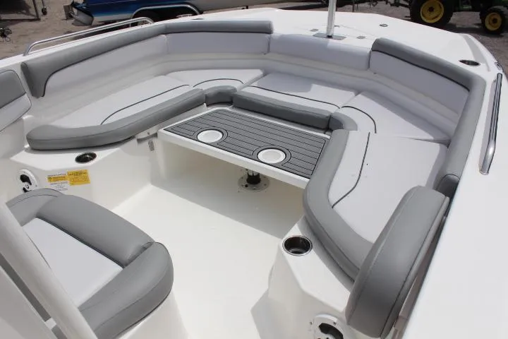 Slide: The Image of 2023 NauticStar 231 Hybrid boat interior with cushioned seating and table. - 10