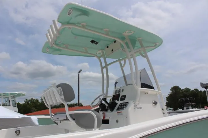 Slide: The Image of 2023 NauticStar 231 Hybrid boat with T-top and dual helm seats. - 12