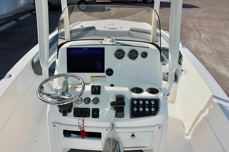 Slide: The Image of 2023 NauticStar 231 Hybrid boat console with steering wheel and gauges. - 15
