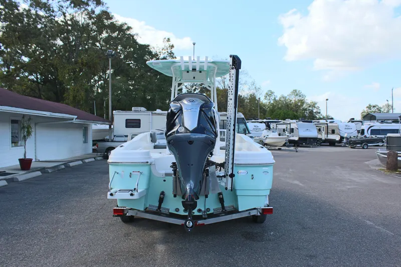 Slide: The Image of 2023 NauticStar 231 Hybrid boat, rear view, parked in a marina lot. - 5