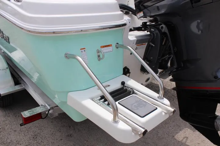Slide: The Image of 2023 NauticStar 231 Hybrid boat stern with swim ladder and outboard motor. - 7