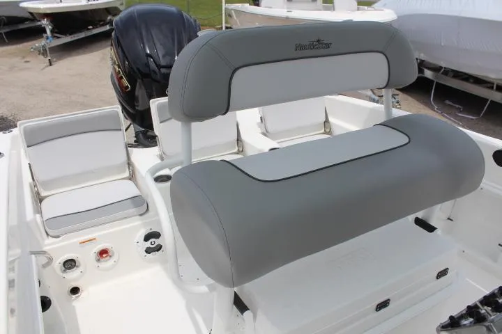 Slide: The Image of 2023 NauticStar 231 Hybrid boat interior with cushioned seating and controls. - 9