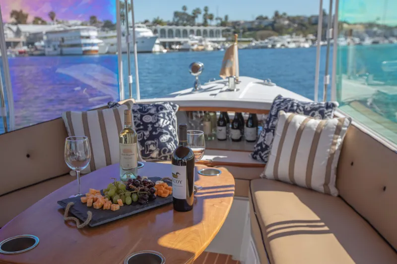 Slide: The Image of Luxurious 2026 Duffy Bay Island boat with wine and cheese setup on deck. - 2