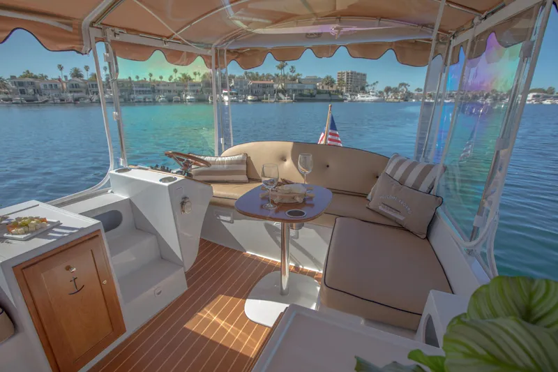 Slide: The Image of Luxurious 2026 Duffy Bay Island boat interior with seating, table, and waterfront view. - 4