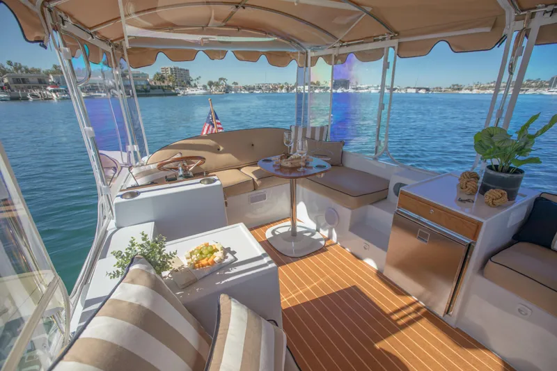 Slide: The Image of Luxurious 2026 Duffy Bay Island boat interior with seating, table, and scenic water view. - 5