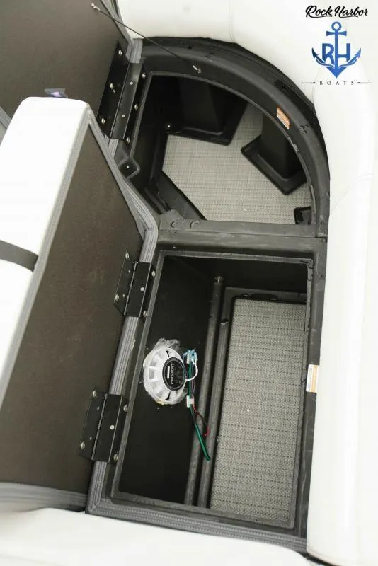 Slide: The Image of Open storage compartment in 2022 Manitou RF 23 Aurora LE VP II boat. - 12