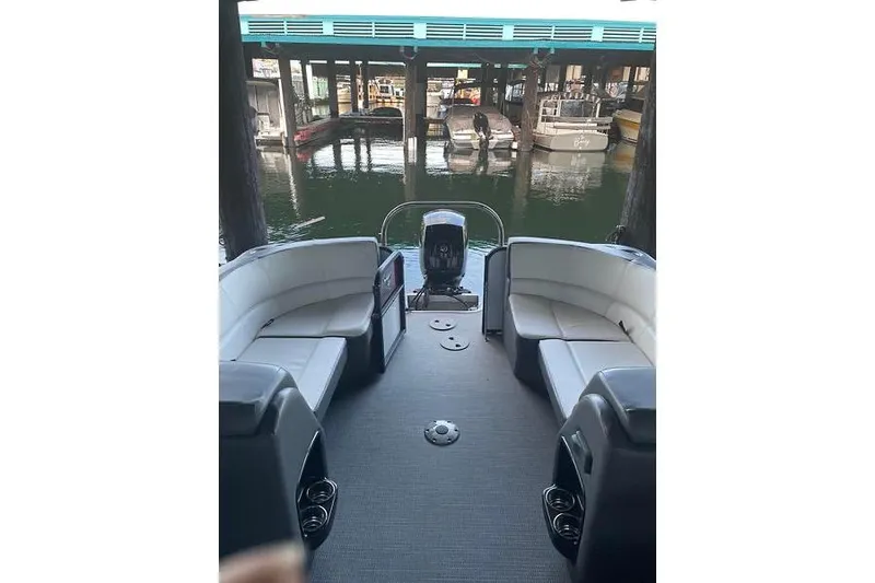 Slide: The Image of 2022 Manitou RF 23 Aurora LE VP II pontoon boat interior with seating and motor view. - 14