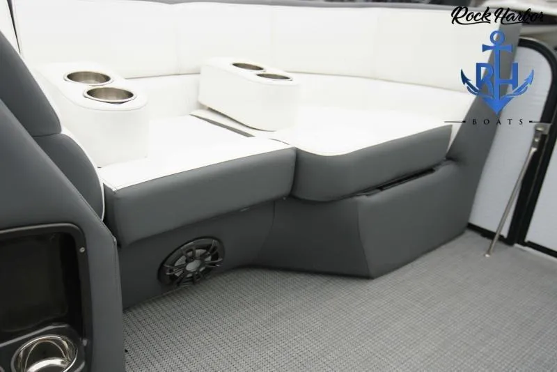 Slide: The Image of 2022 Manitou RF 23 Aurora LE VP II boat interior with cup holders and speaker. - 9