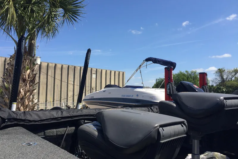 Slide: The Image of 2020 Nitro ZV21 boat docked near palm tree under clear blue sky. - 7