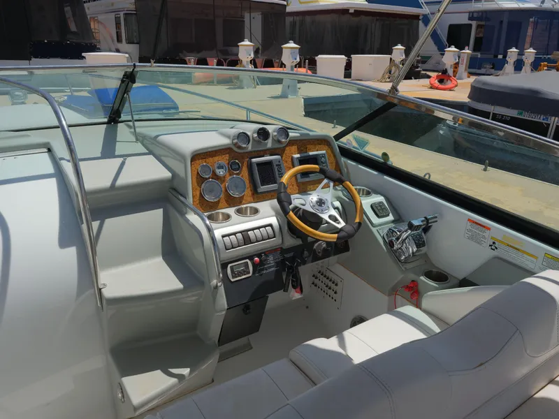 Slide: The Image of 2012 Formula 310 Sun Sport boat cockpit with steering wheel and control panel. - 11