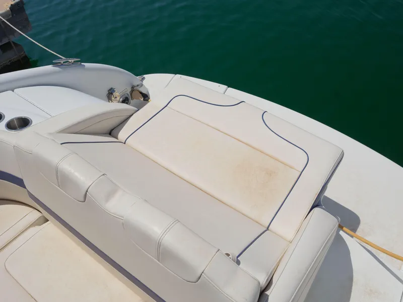 Slide: The Image of 2012 Formula 310 Sun Sport boat with white leather seating by the water. - 12