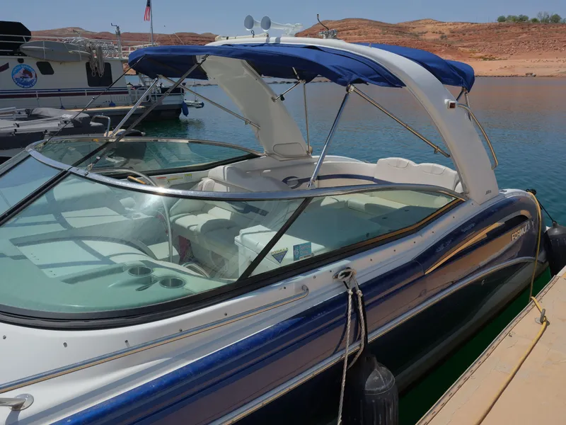 Slide: The Image of 2012 Formula 310 Sun Sport boat docked at a marina with blue canopy. - 16