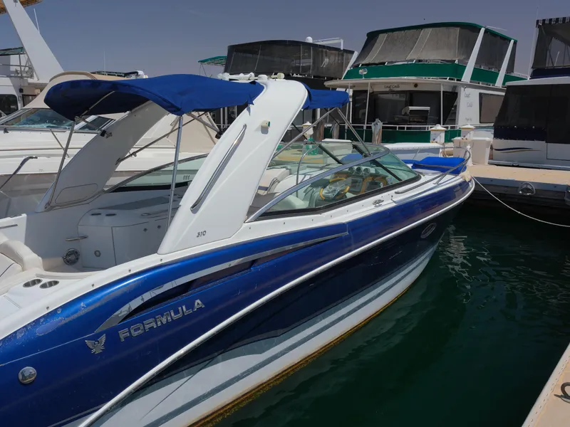 Slide: The Image of 2012 Formula 310 Sun Sport boat docked at a marina. - 17