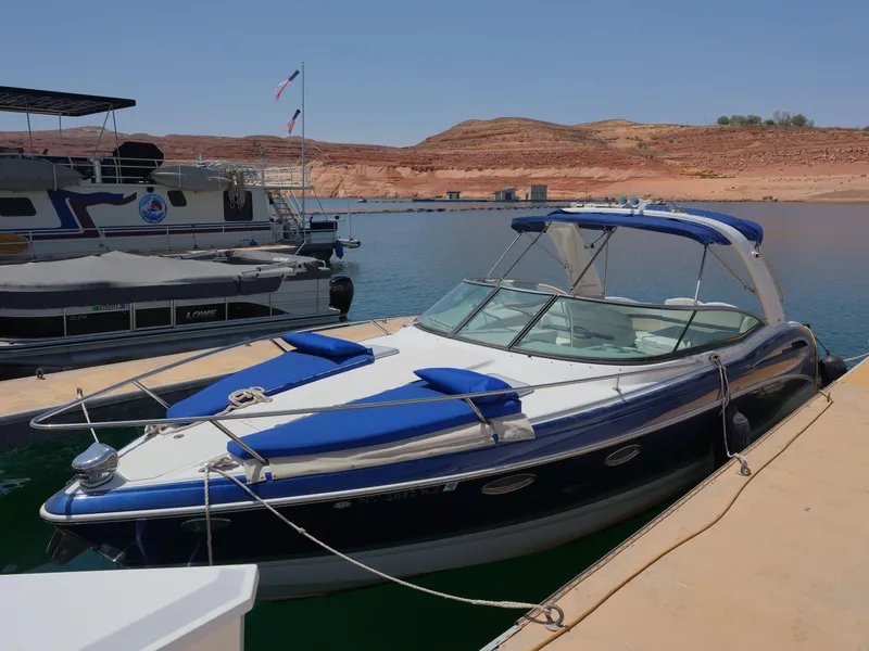 Slide: The Image of 2012 Formula 310 Sun Sport boat docked at a marina with scenic background. - 21