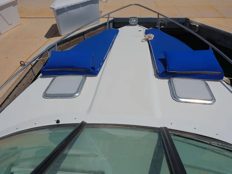 Slide: The Image of 2012 Formula 310 Sun Sport boat with blue cushions on deck. - 23
