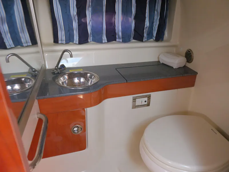 Slide: The Image of 2012 Formula 310 Sun Sport boat bathroom with sink, toilet, and countertop. - 25