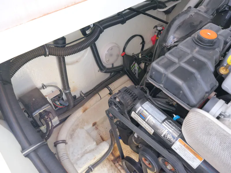 Slide: The Image of 2012 Formula 310 Sun Sport engine compartment with visible wiring and components. - 26