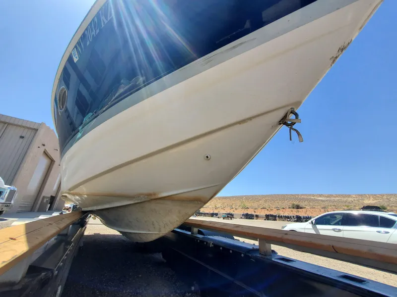 Slide: The Image of 2012 Formula 310 Sun Sport boat on trailer under bright sunlight. - 33