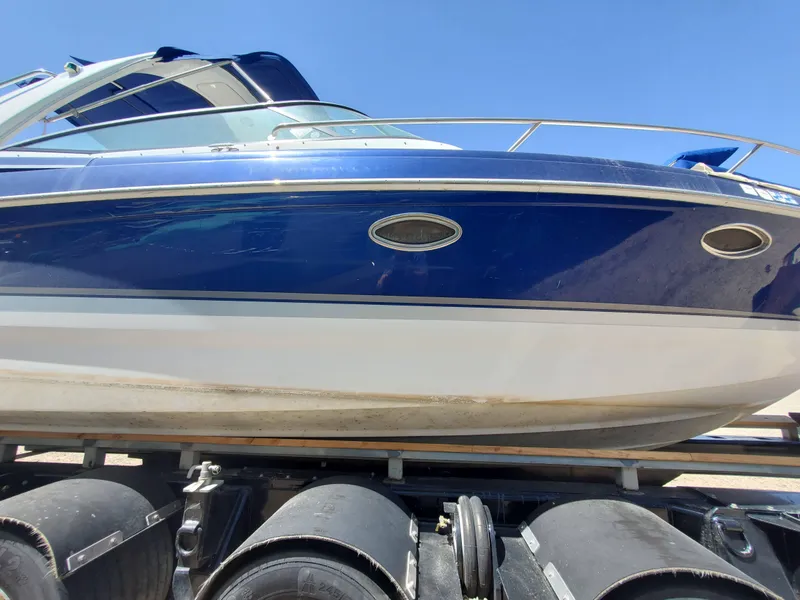 Slide: The Image of 2012 Formula 310 Sun Sport boat on a trailer under a clear blue sky. - 35