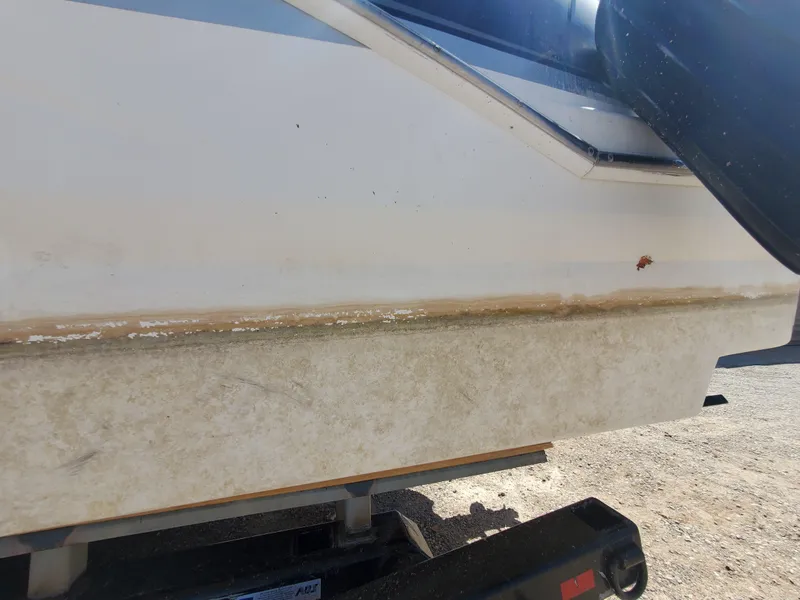 Slide: The Image of 2012 Formula 310 Sun Sport boat hull on trailer, showing wear and dirt. - 42