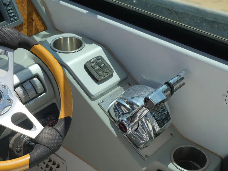 Slide: The Image of 2012 Formula 310 Sun Sport boat helm with steering wheel and throttle controls. - 6