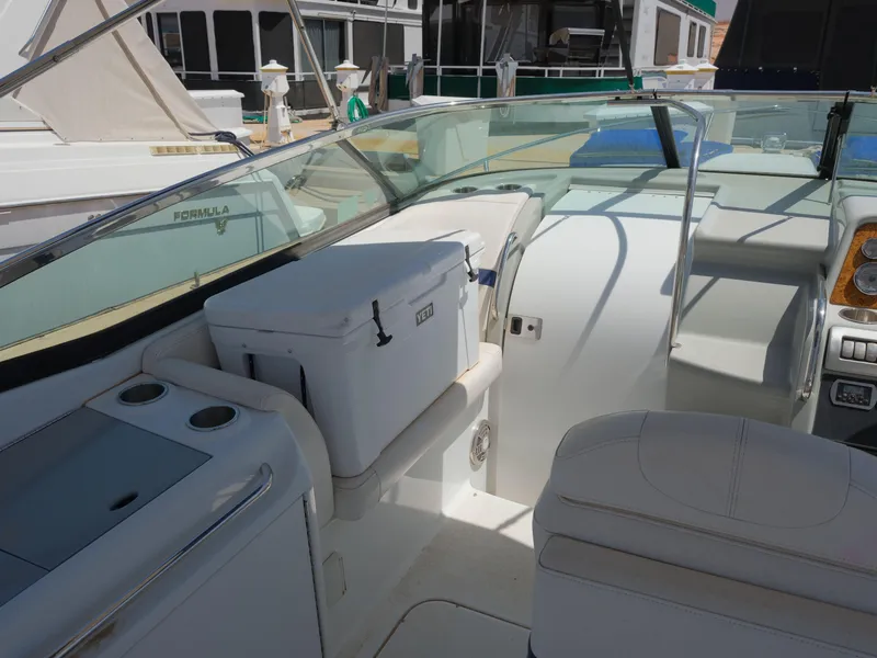 Slide: The Image of 2012 Formula 310 Sun Sport boat interior with seating and cooler. - 9