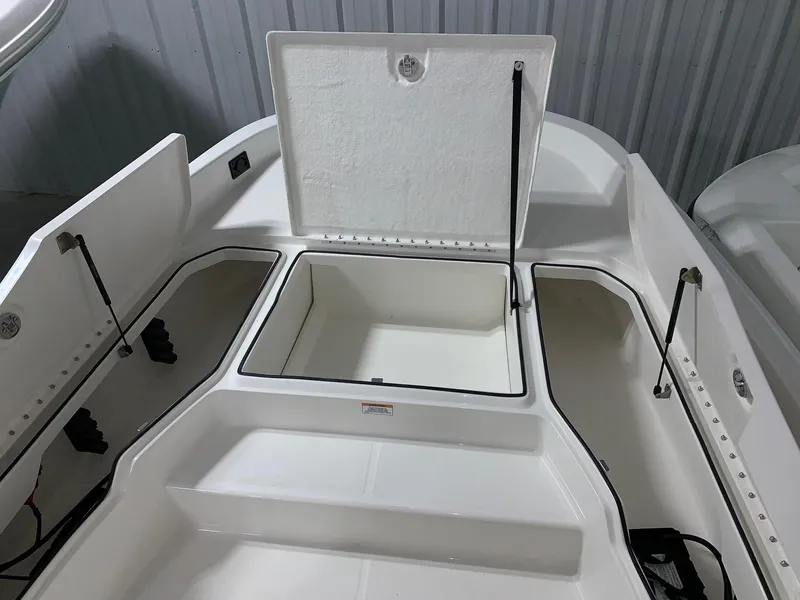 Slide: The Image of 2024 Bayliner T21 Bay boat storage compartments open. - 14