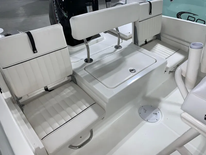 Slide: The Image of 2024 Bayliner T21 Bay boat interior with white seating and storage compartments. - 7