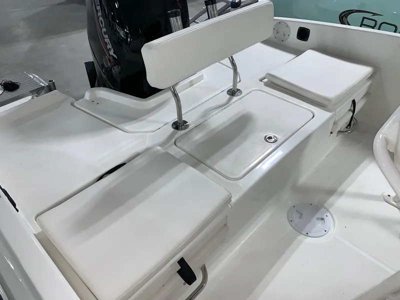 Slide: The Image of 2024 Bayliner T21 Bay boat interior with white seating and storage compartments. - 8