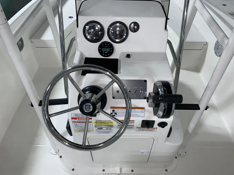 Slide: The Image of 2024 Bayliner T21 Bay boat console with steering wheel and gauges. - 9