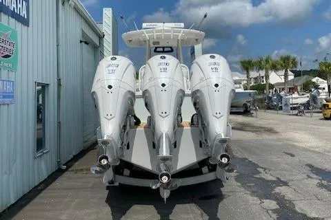 Slide: The Image of 2023 Regulator 34 boat with triple Yamaha 300 engines at a marina. - 4
