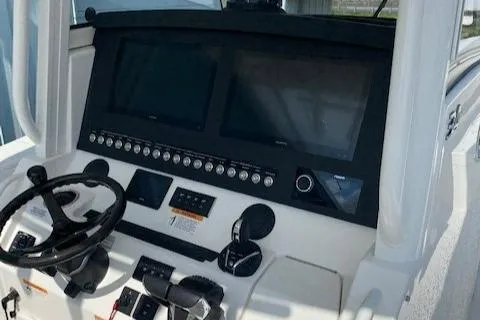 Slide: The Image of 2023 Regulator 34 boat dashboard with dual screens and steering wheel. - 7