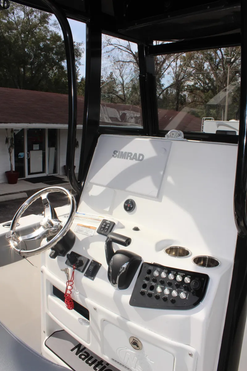 Slide: The Image of 2023 NauticStar 251 Hybrid boat console with steering wheel and controls. - 11