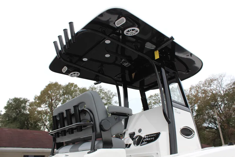Slide: The Image of 2023 NauticStar 251 Hybrid boat with T-top and rod holders. - 19