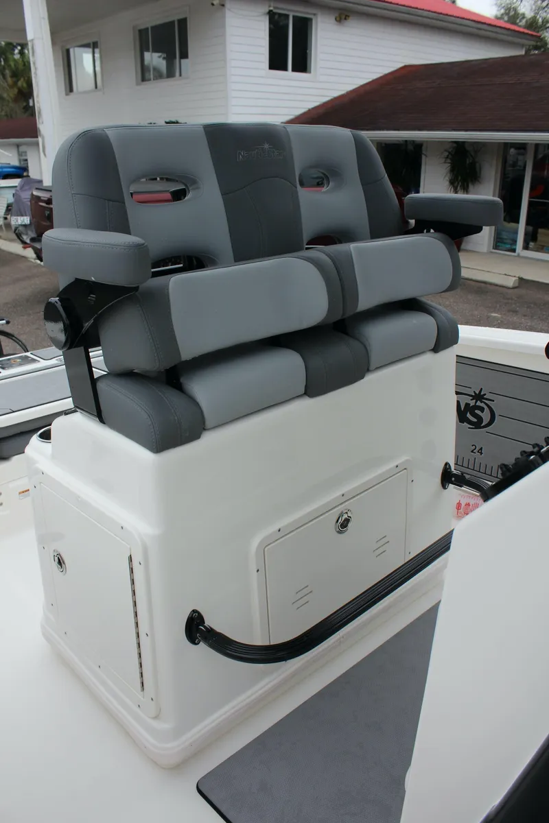 Slide: The Image of 2023 NauticStar 251 Hybrid boat with cushioned seating and storage compartment. - 20