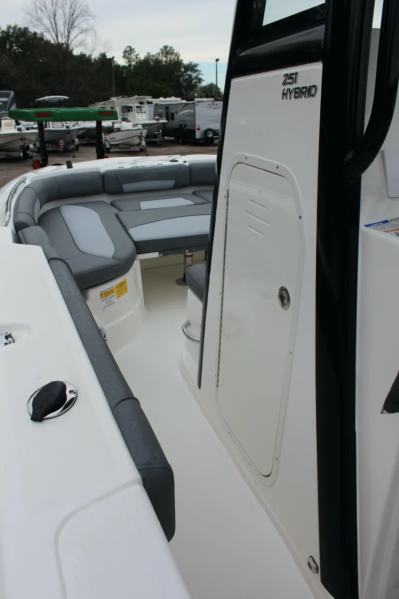 Slide: The Image of 2023 NauticStar 251 Hybrid boat interior with cushioned seating and storage. - 21