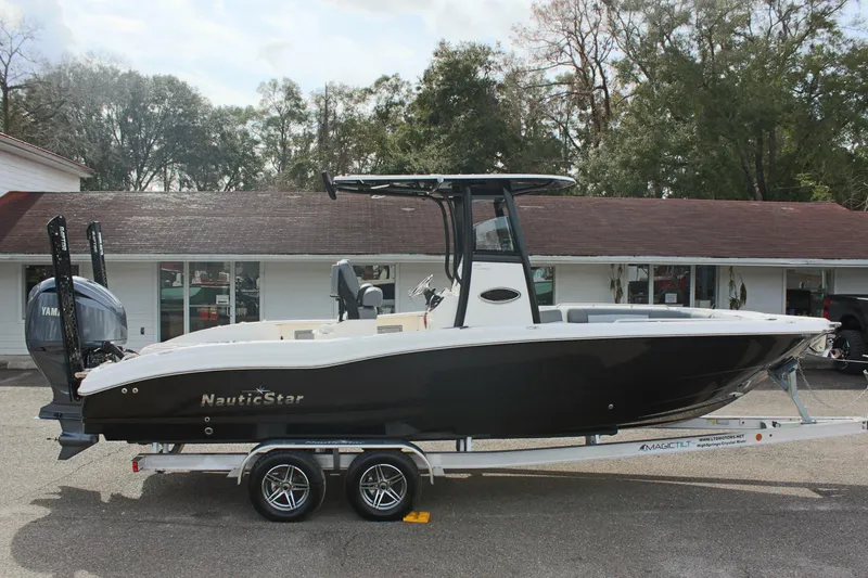 Slide: The Image of 2023 NauticStar 251 Hybrid boat on trailer, parked outdoors. - 3