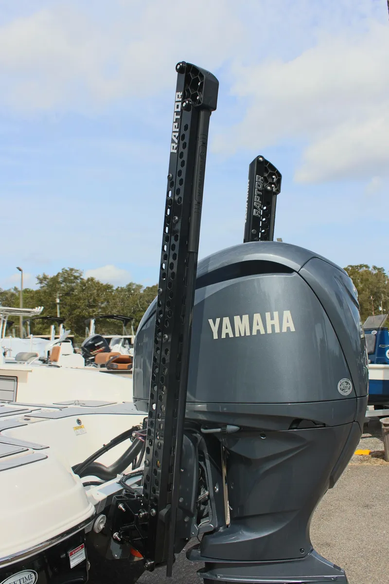 Slide: The Image of 2023 NauticStar 251 Hybrid boat with Yamaha outboard motor, docked outdoors. - 7