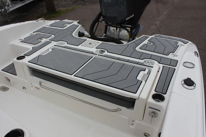 Slide: The Image of 2023 NauticStar 251 Hybrid boat deck with storage compartments and motor. - 9