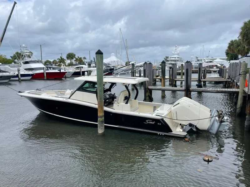 The Image of 2025 Scout 377 LXF boat docked at a marina on a cloudy day. - 0