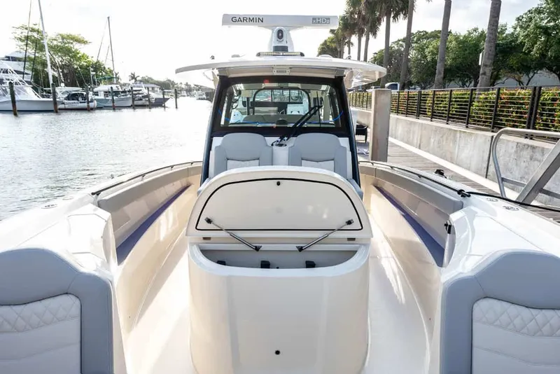 Slide: The Image of Scout 377 LXF 2026 boat at dock with open storage compartment. - 11