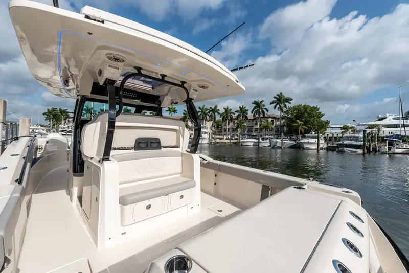 Slide: The Image of Scout 377 LXF 2026 boat docked at marina with palm trees. - 16