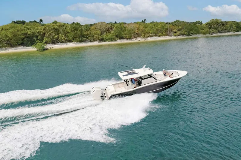 Slide: The Image of Scout 377 LXF 2026 boat cruising on calm coastal waters. - 19
