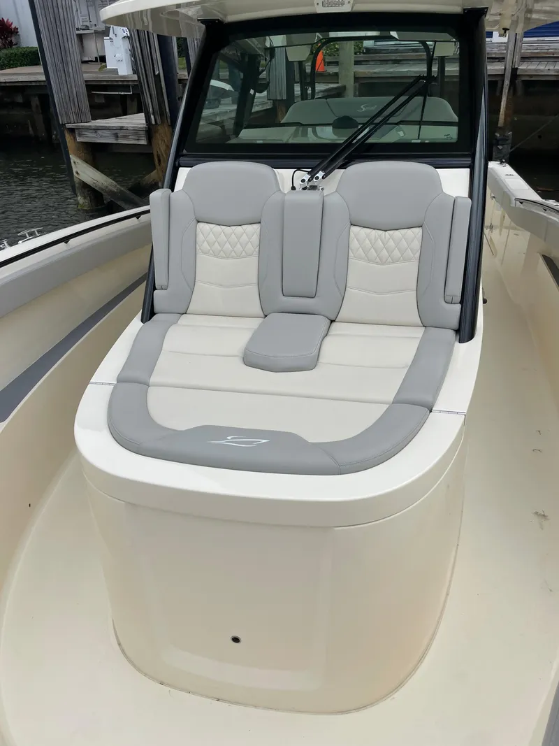 Slide: The Image of 2025 Scout 377 LXF boat with luxurious seating at the dock. - 3