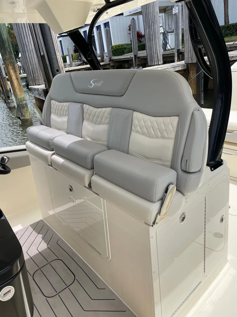 Slide: The Image of 2025 Scout 377 LXF boat interior seating with luxurious gray and white upholstery. - 6