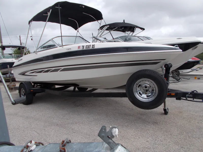 The Image of 2008 Glastron GT 205 boat on a trailer with a black bimini top. - 0